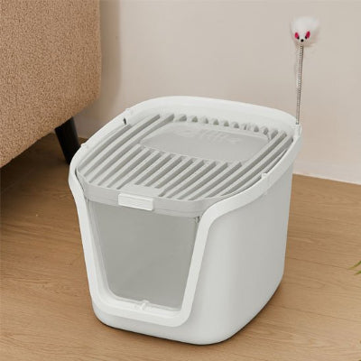 Bac à litière Chat blanc avec un jouet